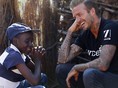 David Beckham brought joy to villagers in Swaziland on a visit to the drought-hit region where his charity work is saving hundreds of lives. He is pictured talking to 14-year-old Sebenelle